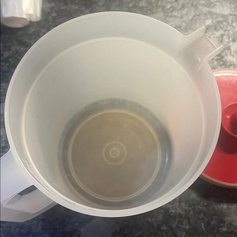 1 1/2 qt semi sheer And Brick Red Plastic Pitcher by Tupperware. Push button lid
